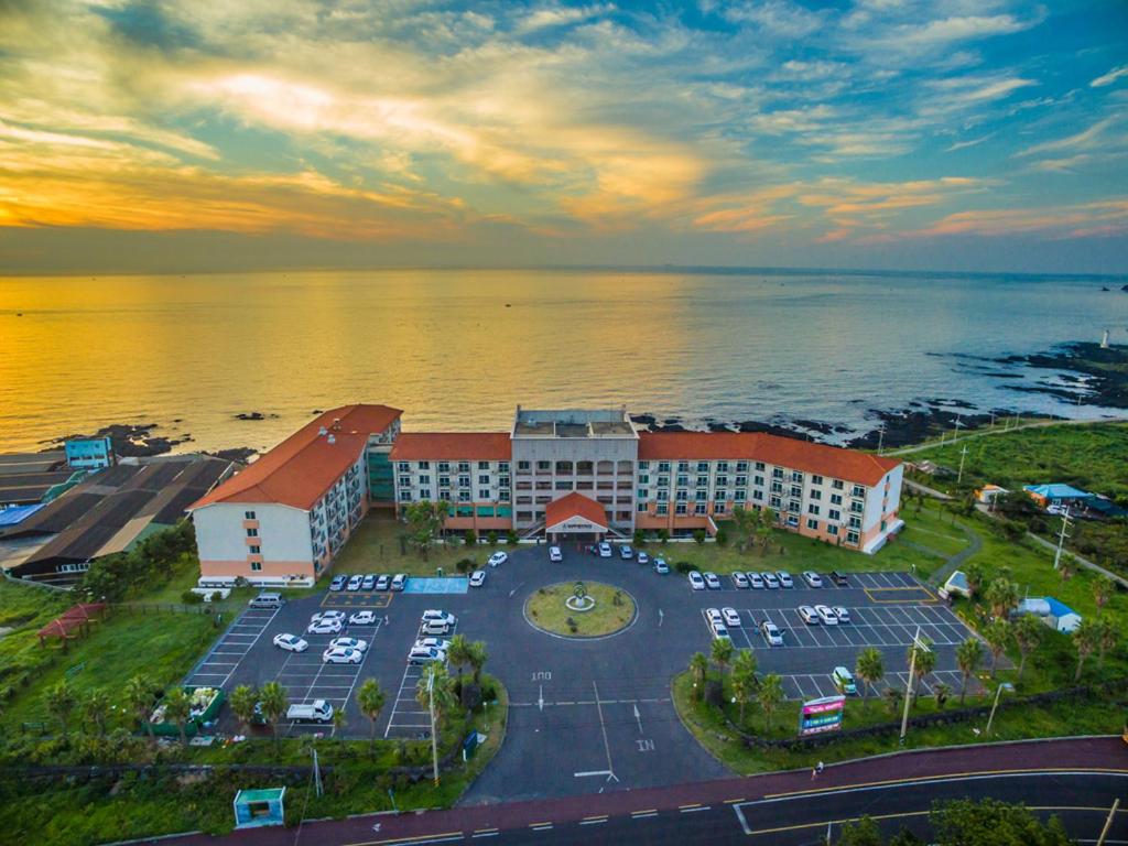 an aerial view of a building with a parking lot at Jeju Ilsung Beach Condo in Jeju