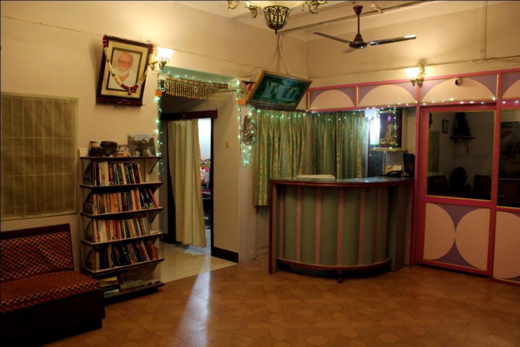 ein Wohnzimmer mit einer Bar und einem Bücherregal in der Unterkunft Sahi River View Guest house in Varanasi