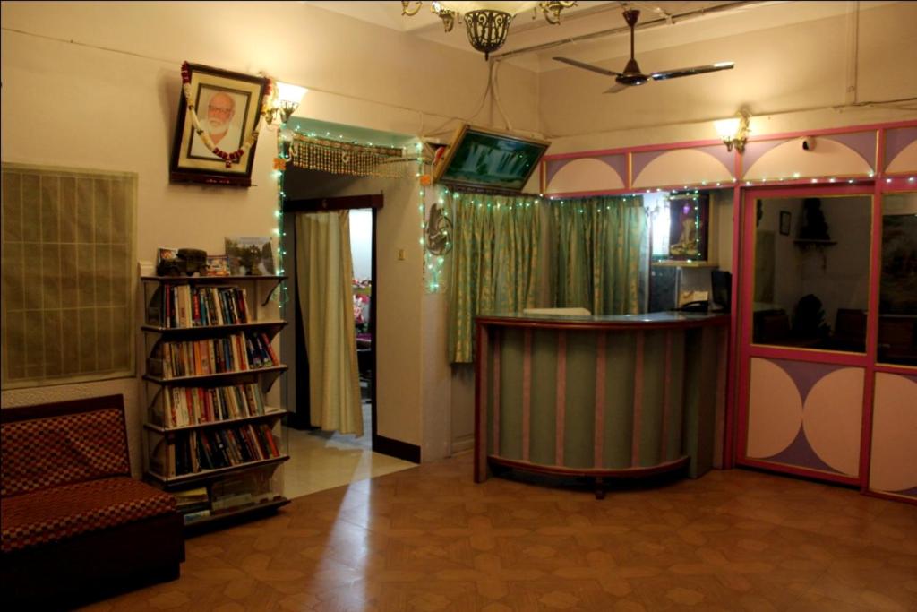 a living room with a bar and a book shelf at Sahi River View Guest house in Varanasi