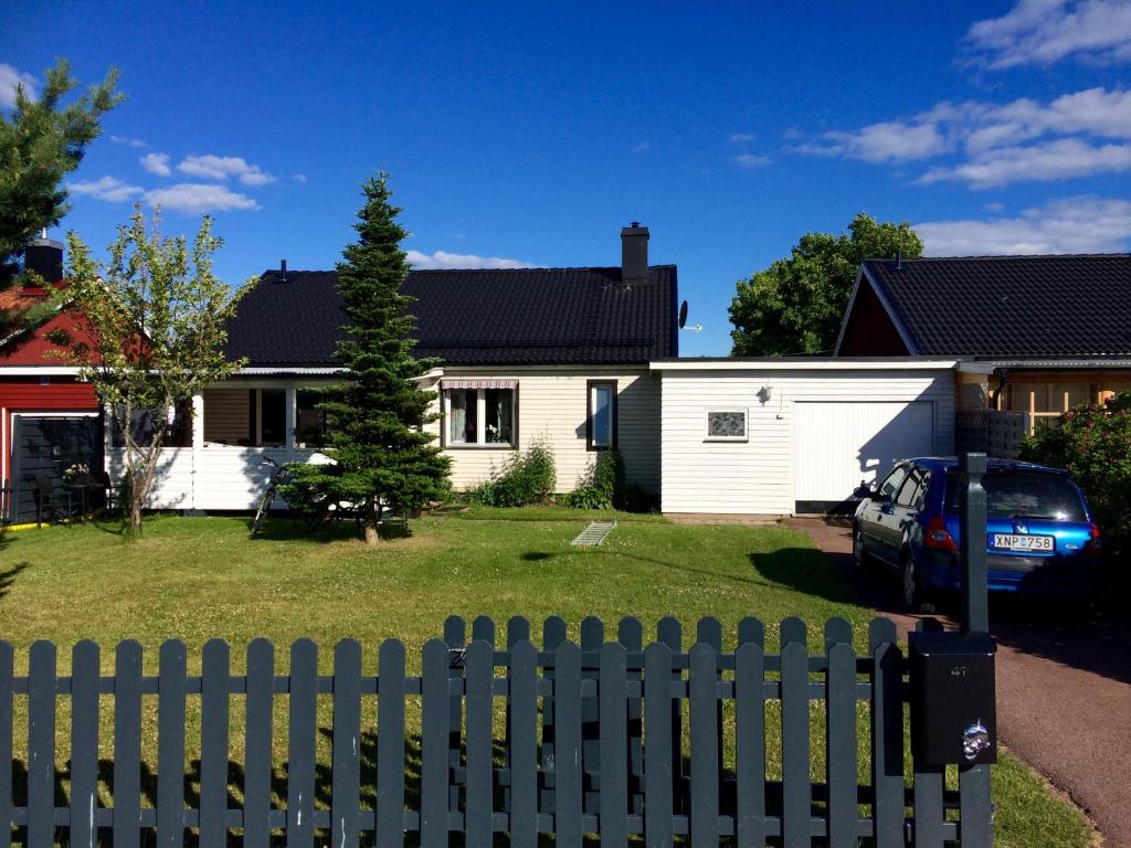 uma cerca branca em frente a uma casa em Utmelandsvägen 41 Helt hus em Mora