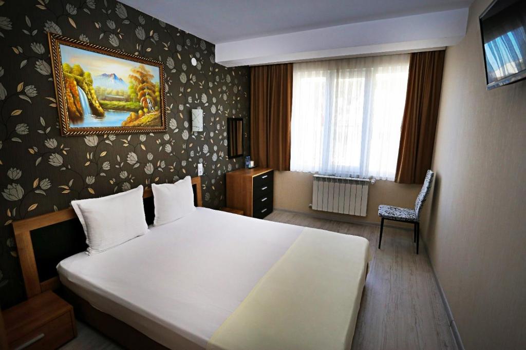 Tempat tidur dalam kamar di Apart Hotel Central