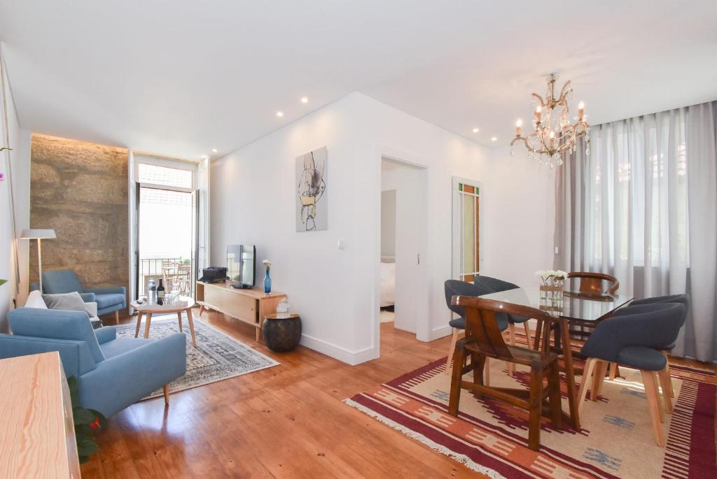 a living room with a table and a dining room at Oporto Lovely House in Porto
