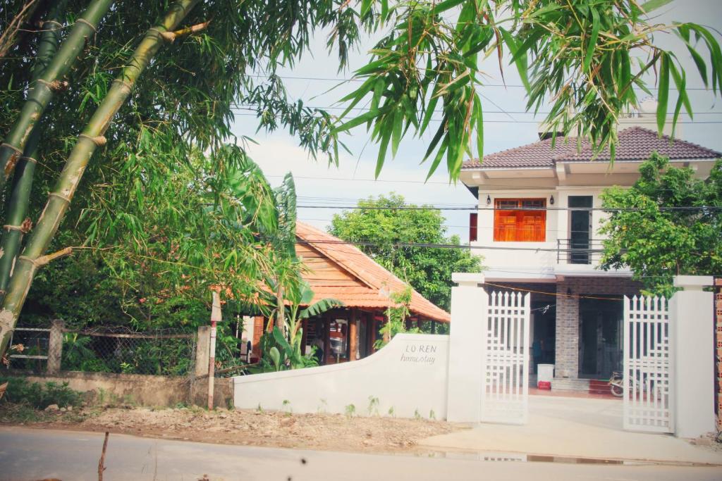 a white house with a ramp in front of it at Loren Homestay in Phong Nha