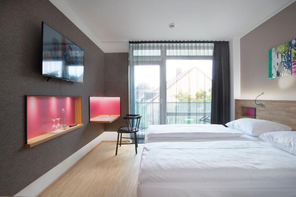 Postel nebo postele na pokoji v ubytování fab Hotel