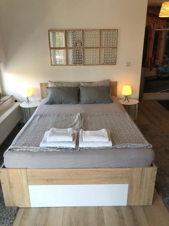 a bedroom with a bed with two pillows on it at Luma 2 in Osijek