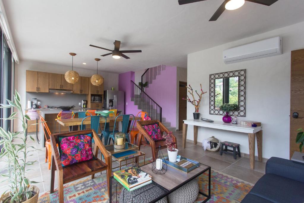a living room with a dining room and a kitchen at Casa Malva in Sayulita