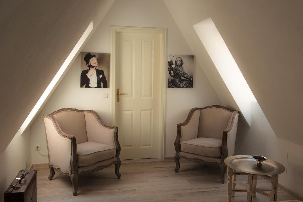 a hallway with two chairs and a white door at Ferienheim Kuckuckswinkel - Familiensuite Marlene in Schöna