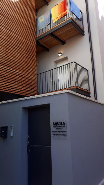 a building with a door and a balcony at Aquila in Arco