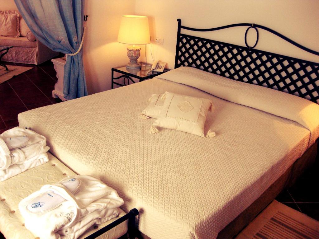 Postel nebo postele na pokoji v ubytování Hotel Monti Di Mola