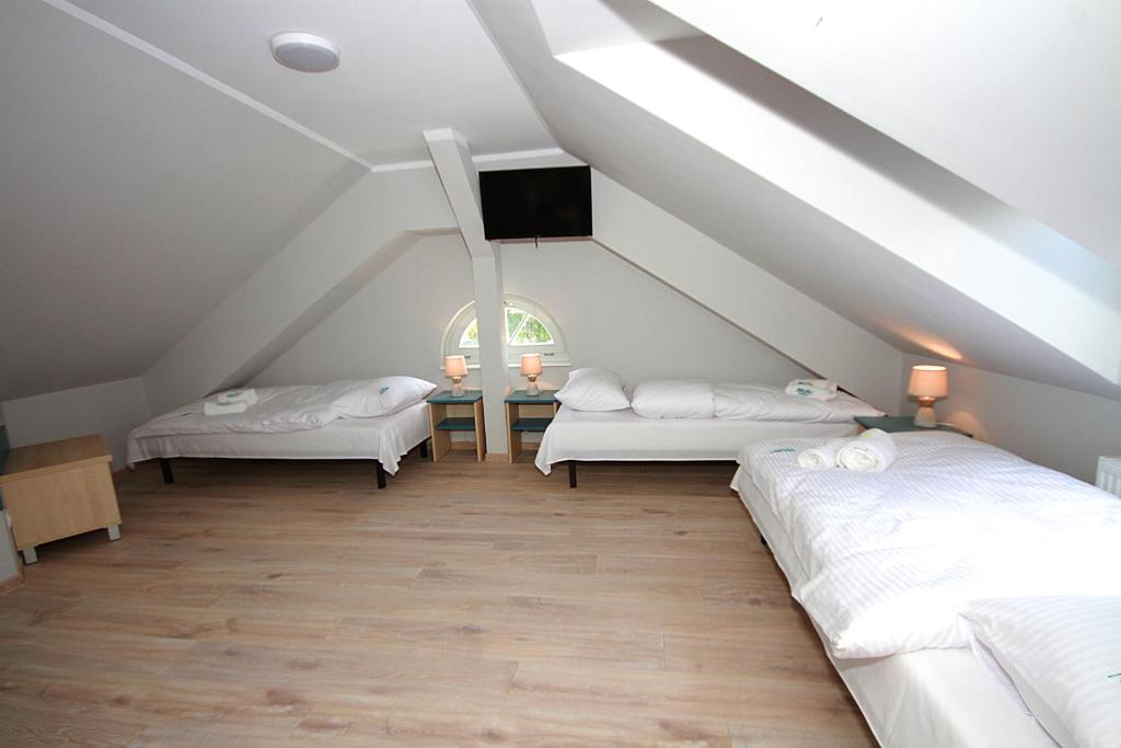 Postel nebo postele na pokoji v ubytování Willa Park Apartamenty