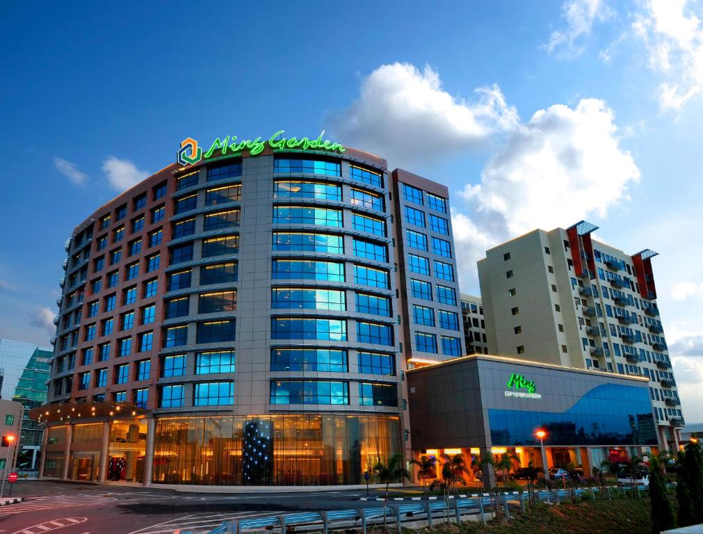 a large building with a sign on top of it at Ming Garden Hotel & Residences in Kota Kinabalu