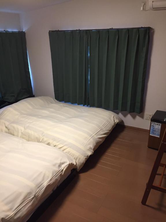 Postel nebo postele na pokoji v ubytování Ryokan Ichinao