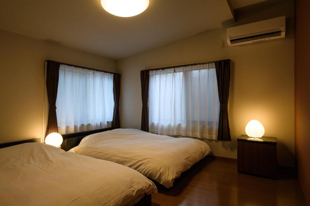 Postel nebo postele na pokoji v ubytování Ryokan Ichinao
