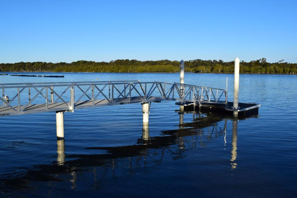 
boats are docked at a dock near a body of water at Pelican Caravan Park in Nambucca Heads

