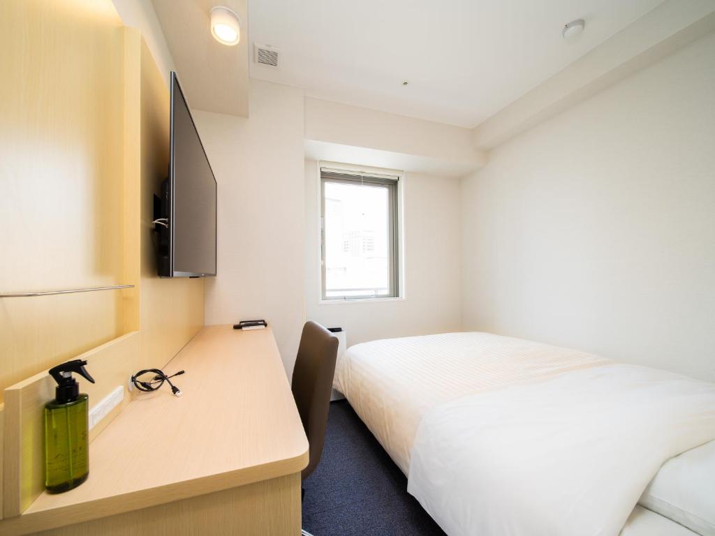 Postel nebo postele na pokoji v ubytování Super Hotel Tokyo Shiba