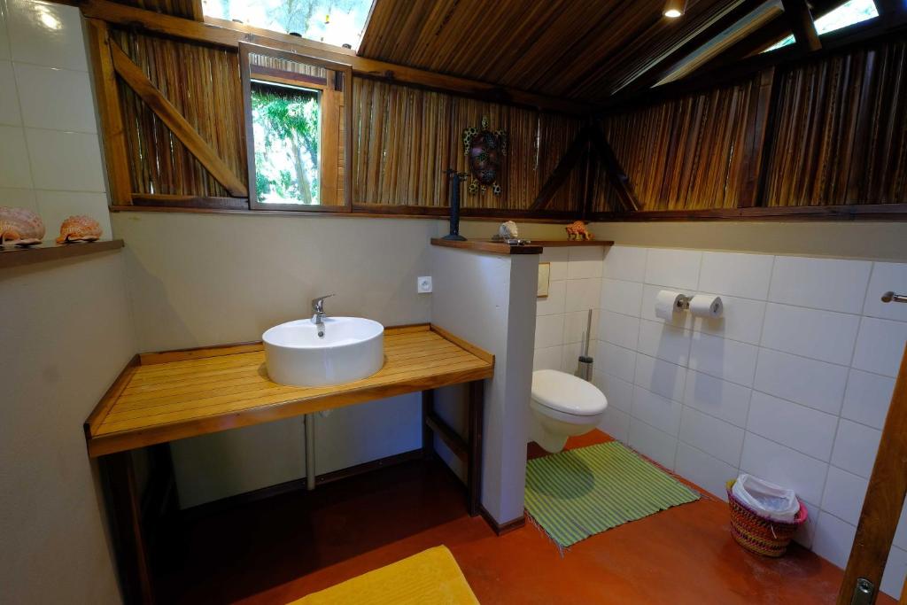 a bathroom with a sink and a toilet at Coco Komba Lodge in Nosy Komba