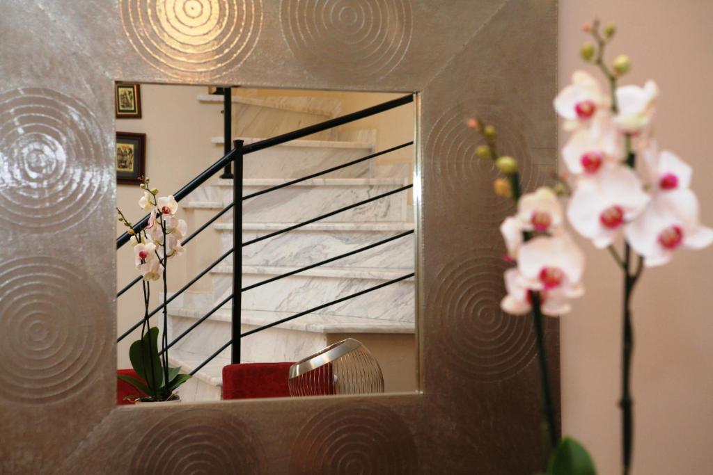 a mirror with a staircase in a room with flowers at Luxury Sunny Home Near to Water-park and Beaches in Ayía Paraskeví