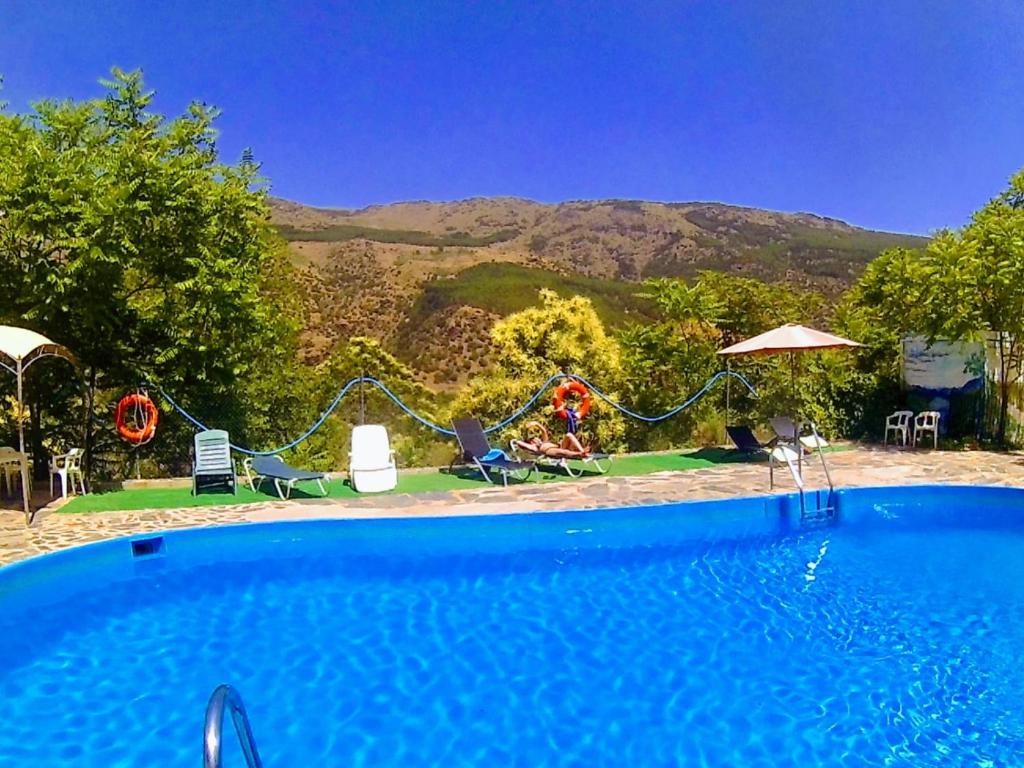 a swimming pool with a view of a mountain at Bungalow Camping Trevélez in Trevélez