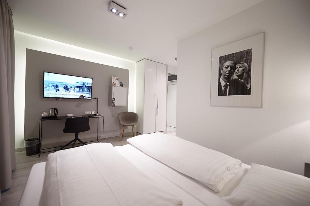 Postel nebo postele na pokoji v ubytování Hotel Amadeus