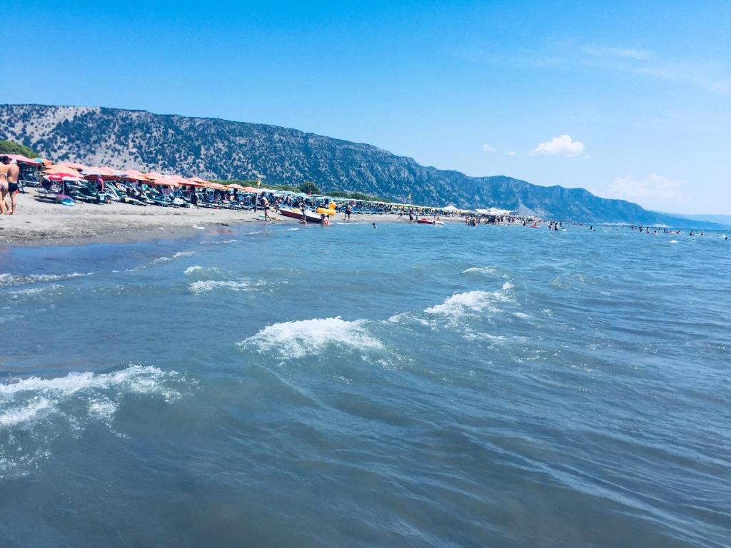 a beach with a bunch of people on the beach at Apartment Celaj Velipoje in Velipojë