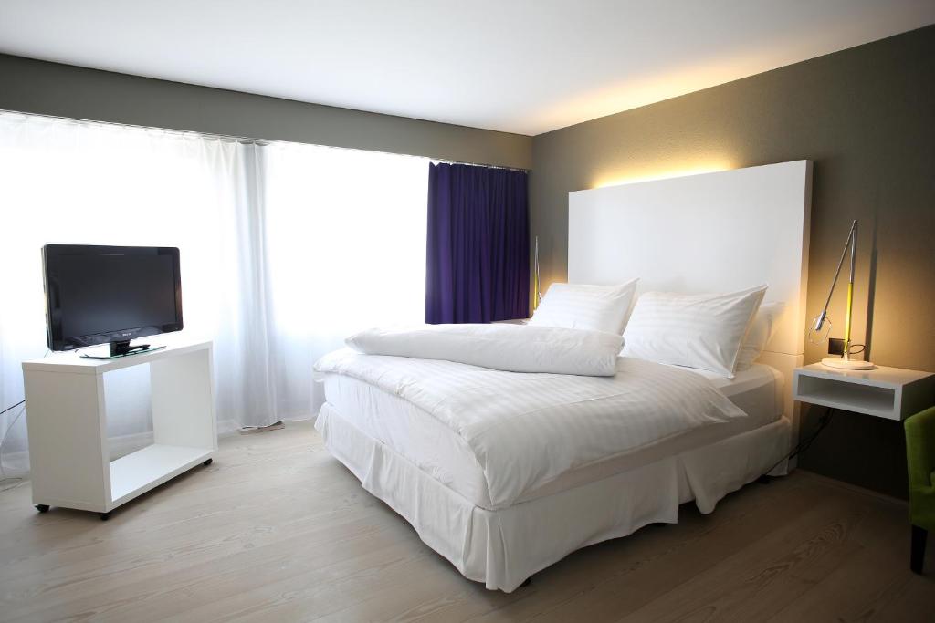 Postel nebo postele na pokoji v ubytování Hotel Restaurant Rössli