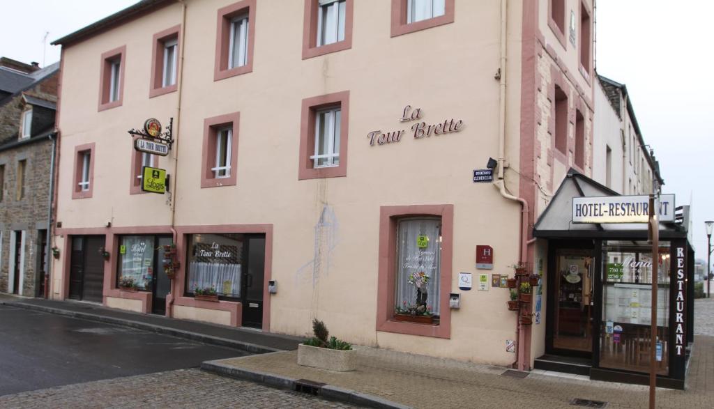 a building on the side of a street at Logis Hôtel et Restaurant La Tour Brette in Pontorson