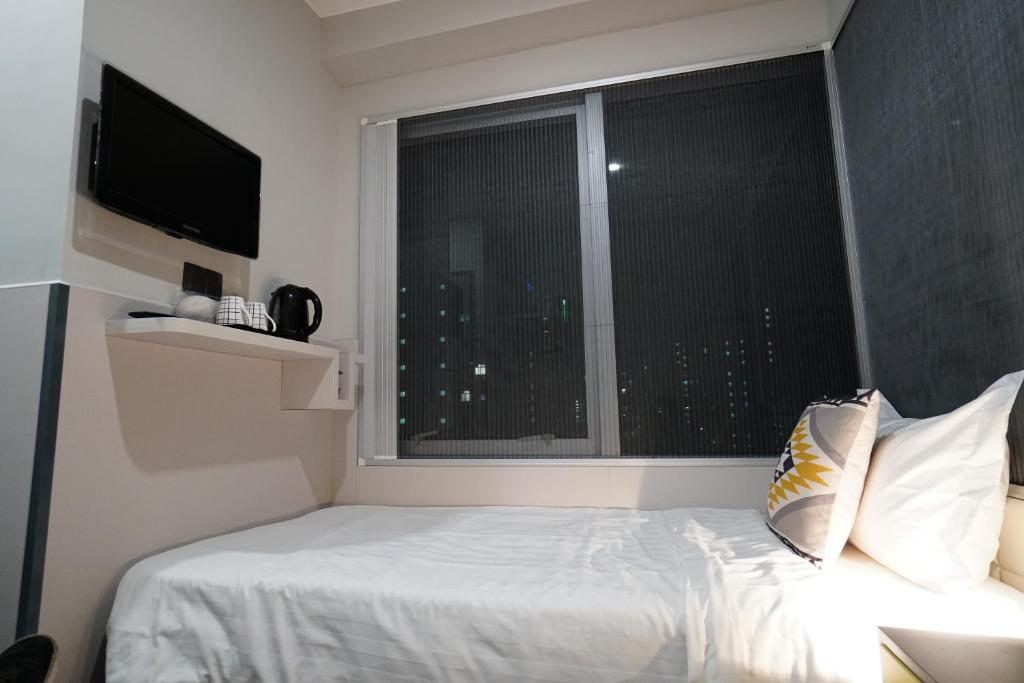 A bed or beds in a room at MK STAY - formerly HOTEL MK