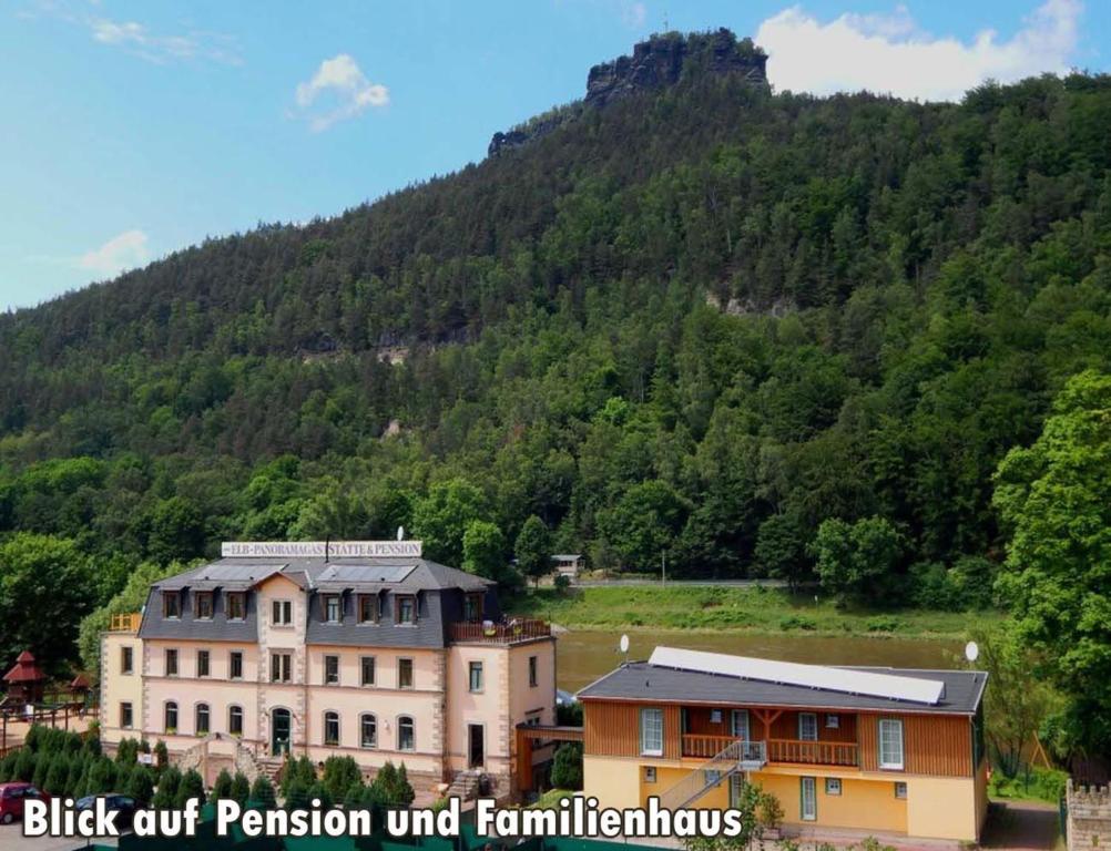 a large building in front of a mountain at Pension Bomätscher in Königstein an der Elbe