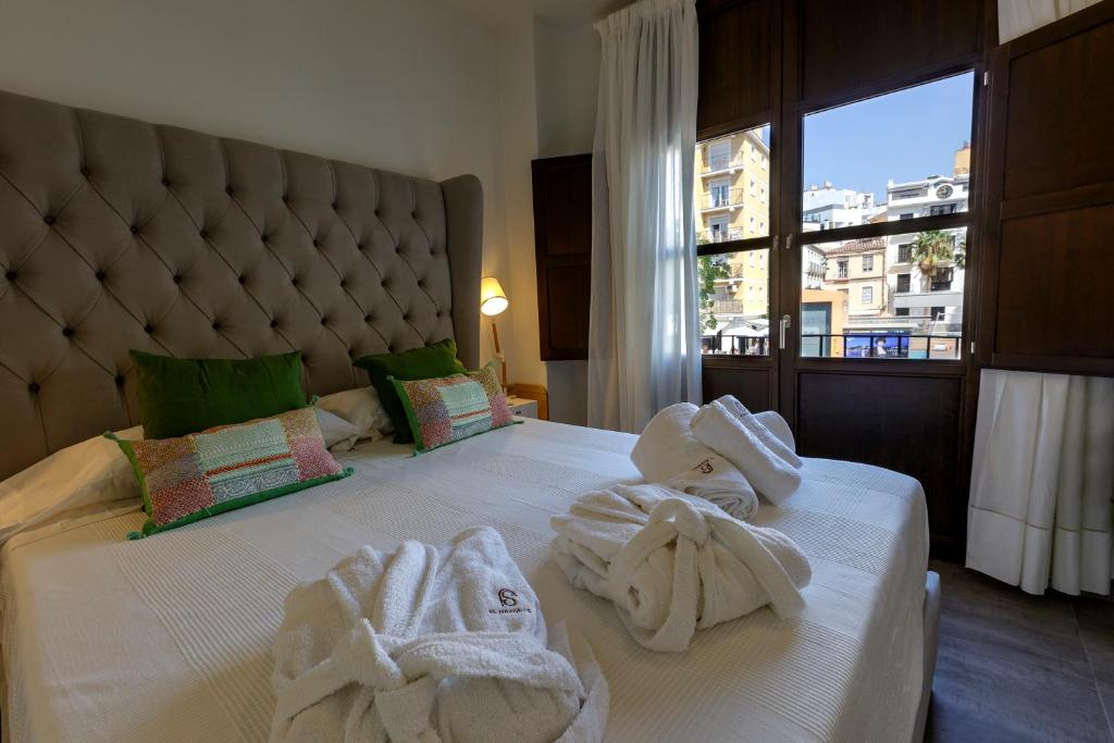 Posteľ alebo postele v izbe v ubytovaní Apartamentos El Marqués