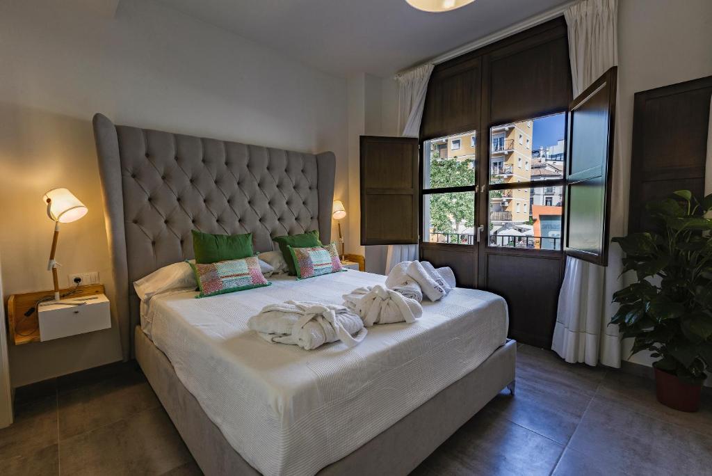 Posteľ alebo postele v izbe v ubytovaní Apartamentos El Marqués