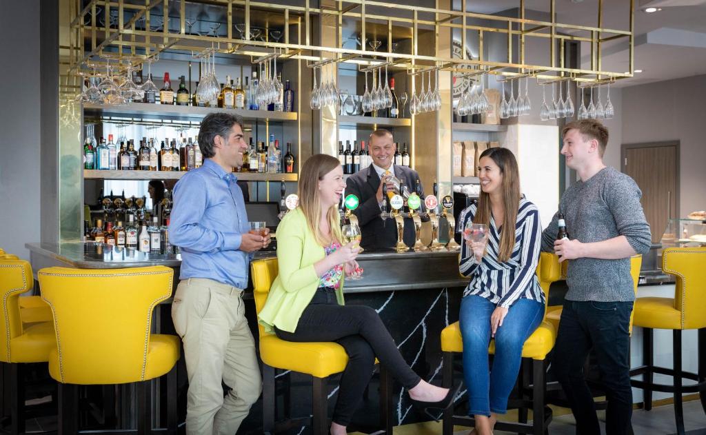 a group of people sitting at a bar at Maldron Hotel Kevin Street, Dublin City in Dublin