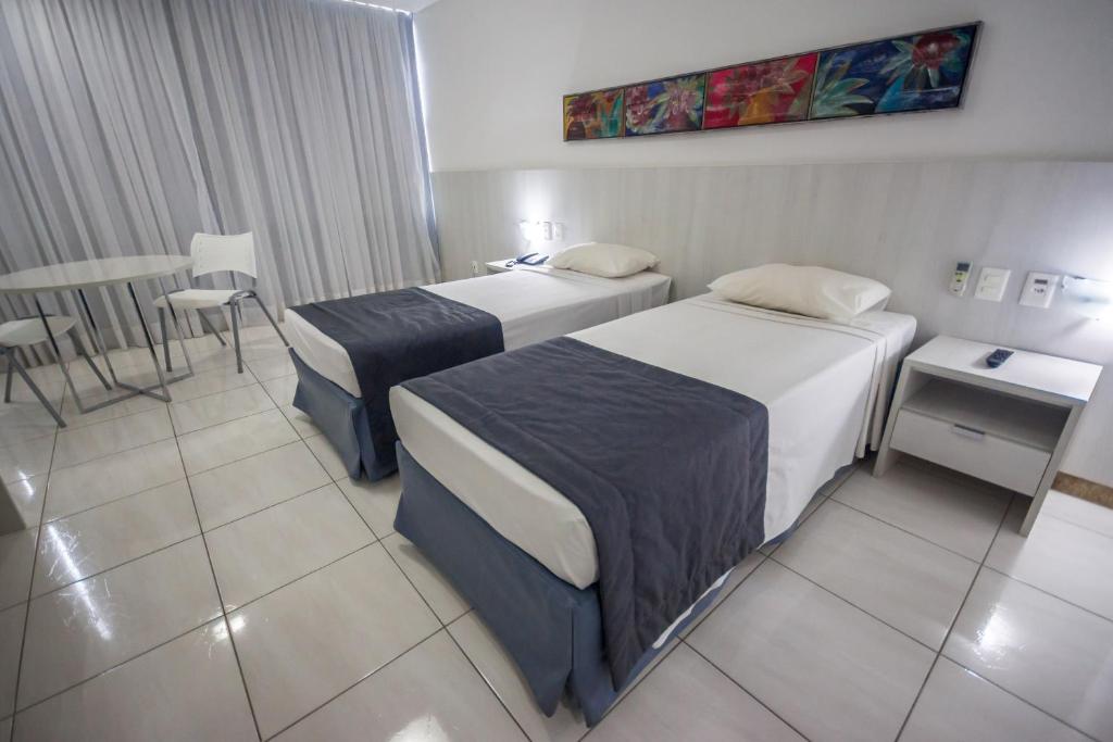 Postel nebo postele na pokoji v ubytování Cambuci Hotel