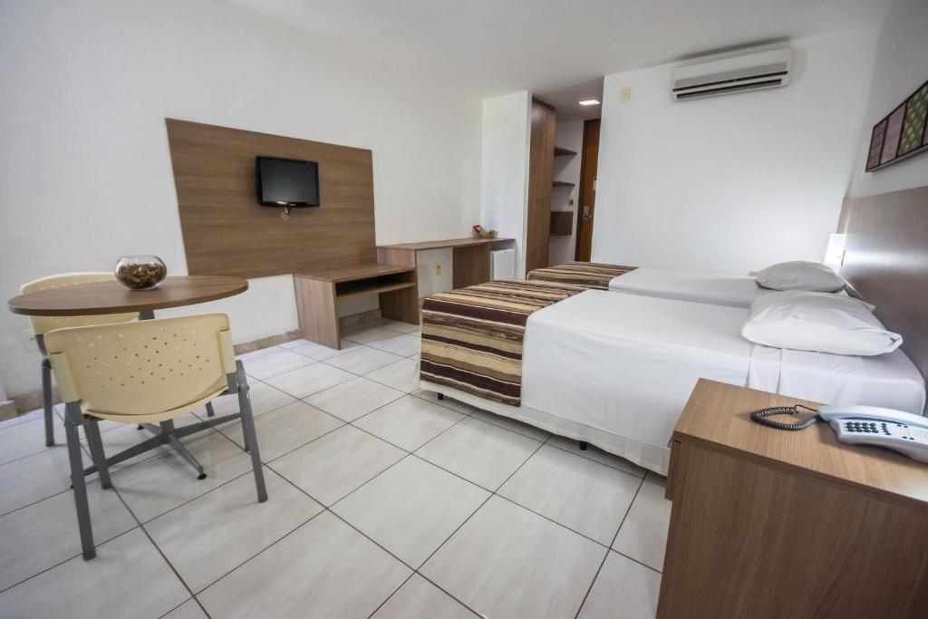 Postel nebo postele na pokoji v ubytování Cambuci Hotel