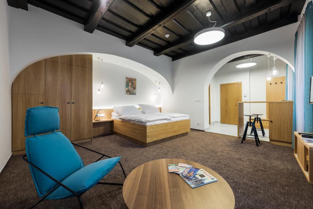 a bedroom with a bed and a desk and a table at Fancy apartments by Prague Castle in Prague
