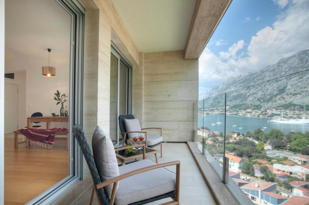 a balcony with a view of the ocean and mountains at Aria Apartments in Kotor