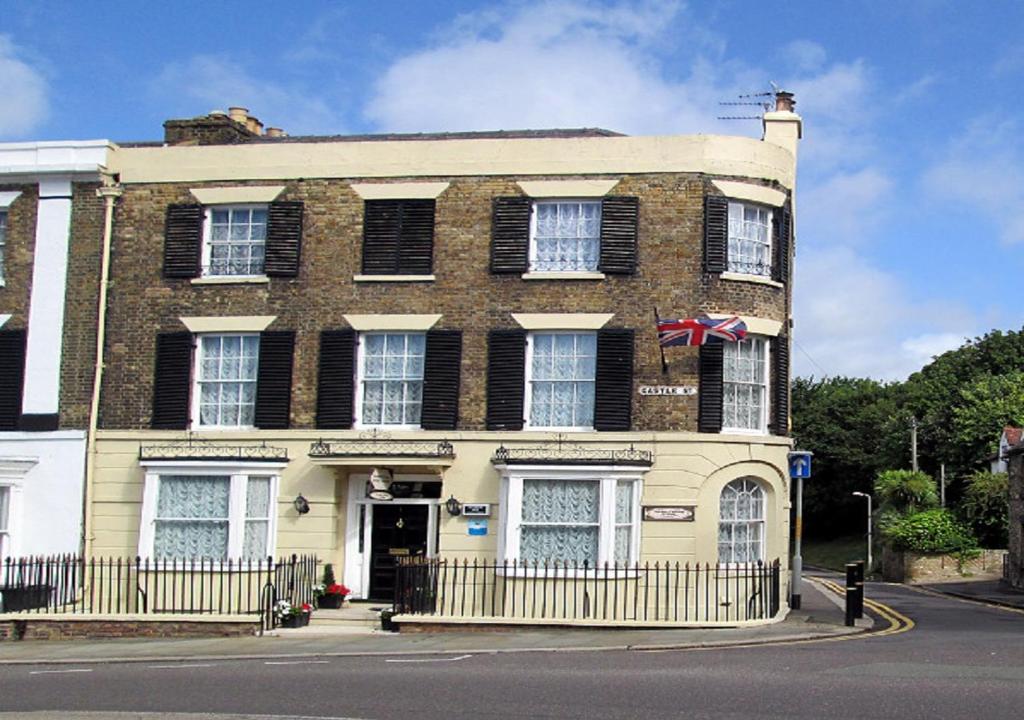 a large brick building with a flag in front of it at Number One Guesthouse in Dover