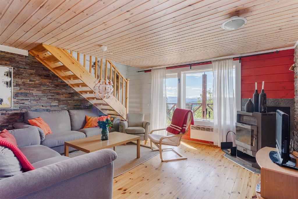 a living room with a couch and a table at Villa Falken in Åre