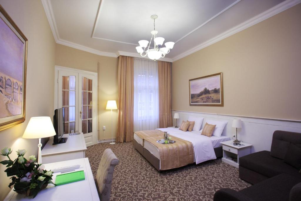 a hotel room with a bed and a couch at Booking Rooms in Belgrade