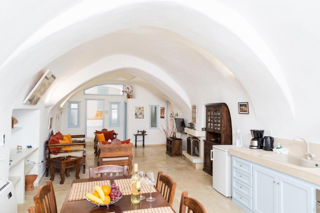 a kitchen and living room with a table and chairs at Chrisanthi Villa in Pyrgos
