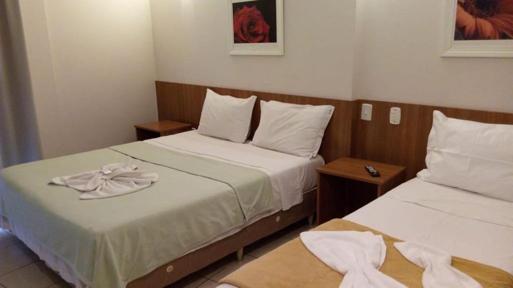 2 Betten in einem kleinen Zimmer mit Handtüchern darauf in der Unterkunft Vital Hotel in Marechal Floriano