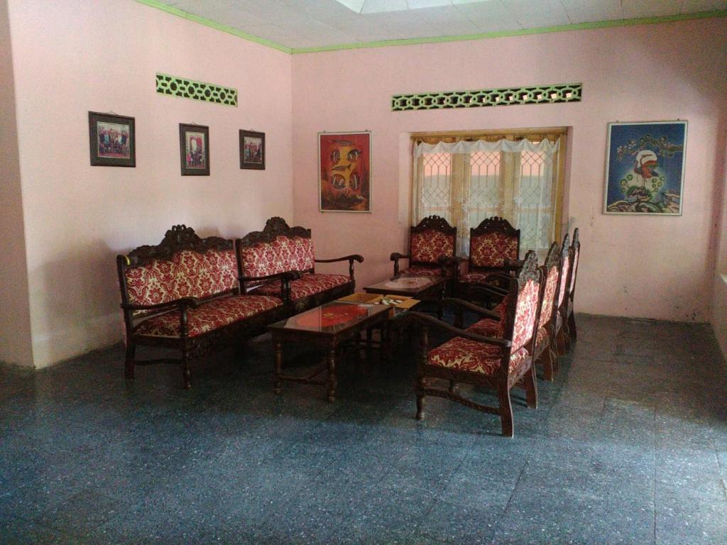 a living room with chairs and a table and a table and chairsktop at Setro Kariyo Homestay in Bantul