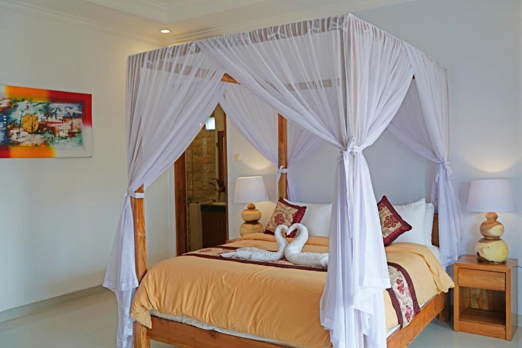 Postel nebo postele na pokoji v ubytování Lebak Bali Residence
