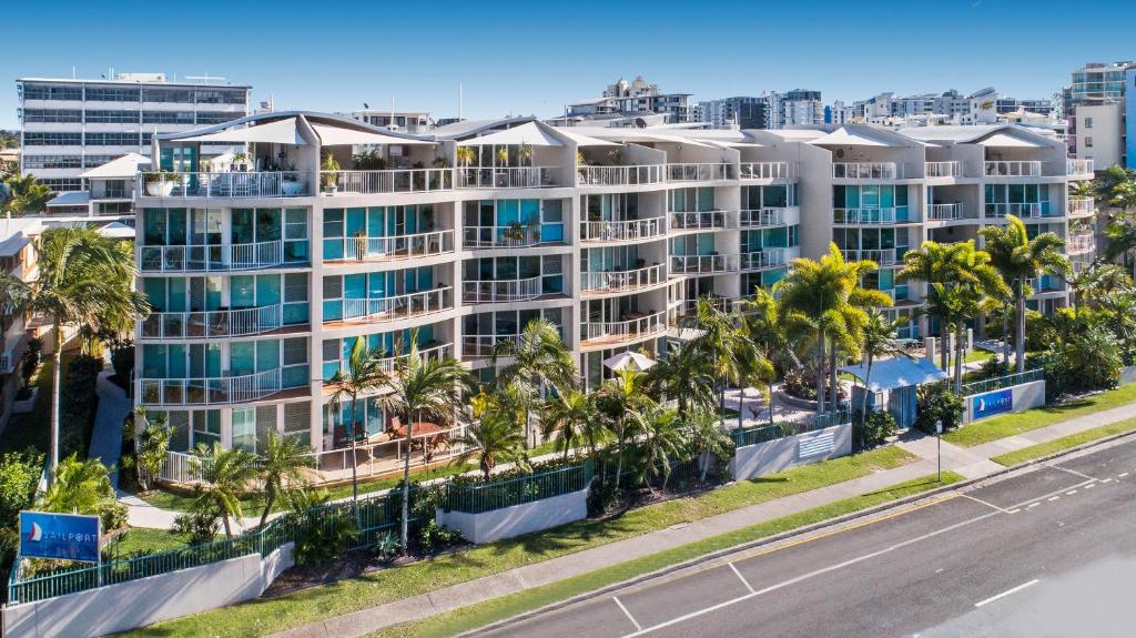 an aerial view of a large apartment building with palm trees at Sailport Mooloolaba Apartments in Mooloolaba