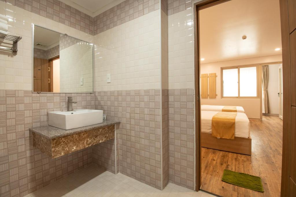 a bathroom with a sink and a bed at Summer Dream Hotel in Phú Quốc