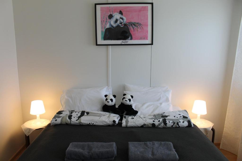 a bedroom with a bed with two pandas on it at Visit Hautakylä in Hautakylä