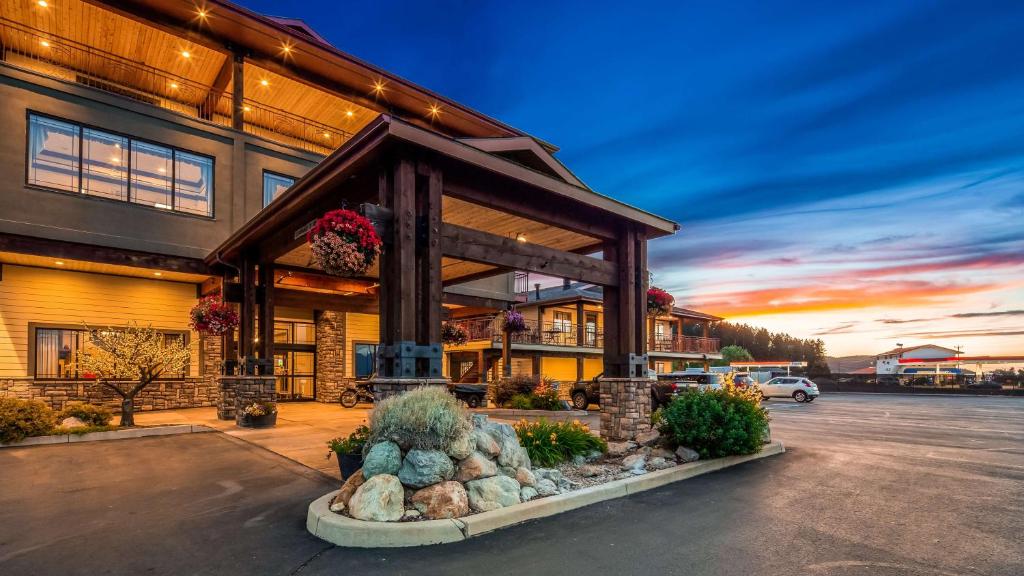 a house with a fireplace in a parking lot at Best Western Plus Flathead Lake Inn and Suites in Kalispell