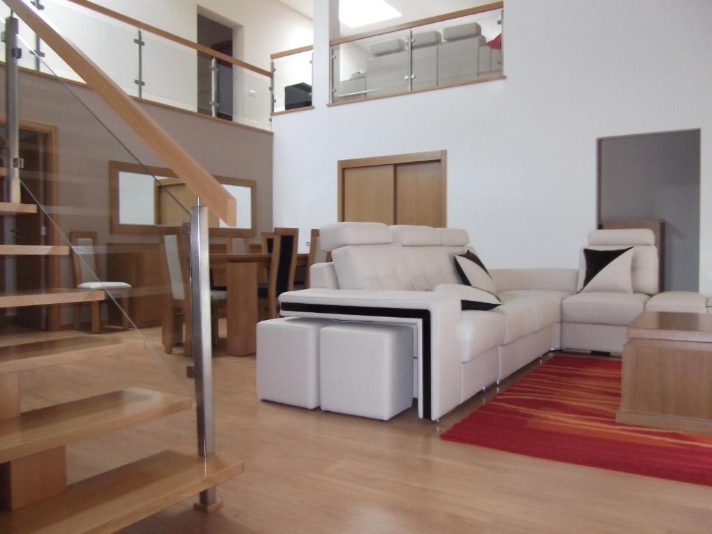 a living room with a white couch and a table at Quinta dos Caibrais in Porcelhe