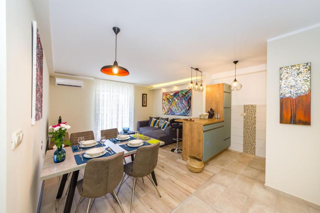 a dining room and living room with a table and chairs at Ema 2BR apt. in old town centre in Zadar