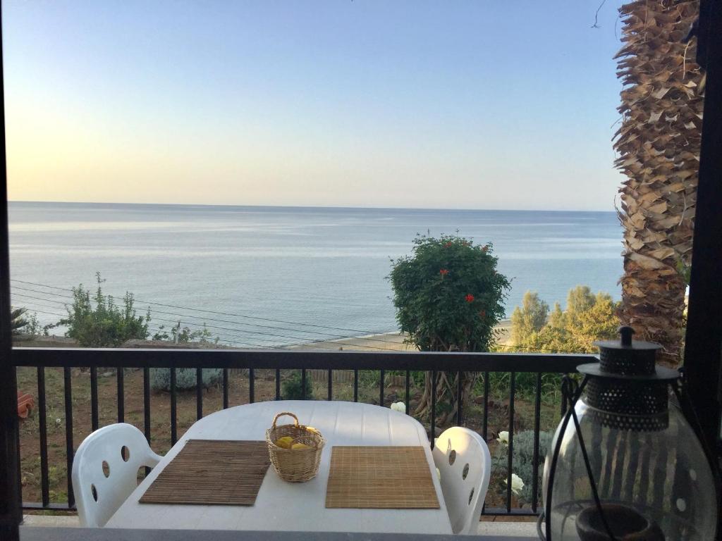 a table on a balcony with a view of the ocean at Apartment with stunning sea view in Pachyammos