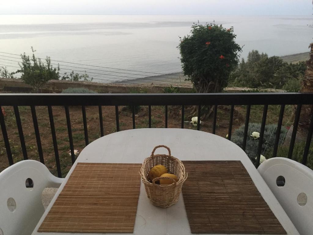 a basket of fruit sitting on a table on a balcony at Apartment with stunning sea view in Pachyammos